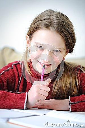 Cute positive girl writing Stock Photo