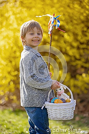 Cute preschool child, boy, holding handmade braided whip made from pussy willow, traditional symbol of Czech Easter used for Stock Photo