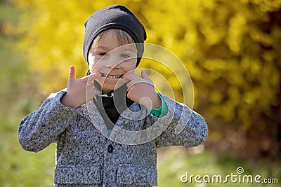 Cute preschool child, boy, holding handmade braided whip made from pussy willow, traditional symbol of Czech Easter used for Stock Photo