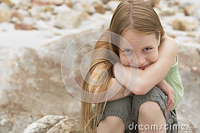 Cute Preteen Girl Sitting On Rock Stock Photo