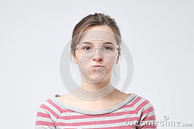 Cute pretty woman blowing her cheeks with pleasure having fun. Stock Photo