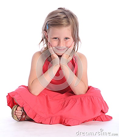 Cute primary school girl sitting cross legged Stock Photo