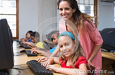 Cute pupils in computer class with teacher Stock Photo