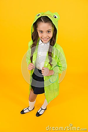 Cute raincoat kids would love. Frog style. Schoolgirl hooded raincoat enjoy fall weather. Rainproof accessories make Stock Photo