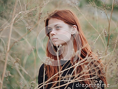 cute red-haired woman grass in field summer nature Stock Photo