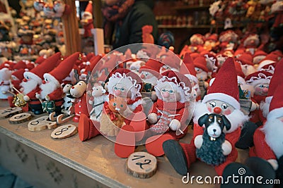 Cute red handmade doll souvenirs in an European Christmas market Editorial Stock Photo