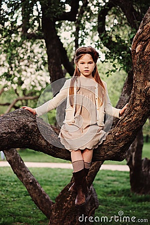 Cute romantic child girl in beige natural dress Stock Photo