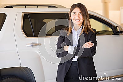 Cute saleswoman in a car dealership Stock Photo