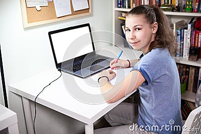 Cute schoolgirl is on distance aducation at home, homeschooling with laptop, isolated monitor screen Stock Photo