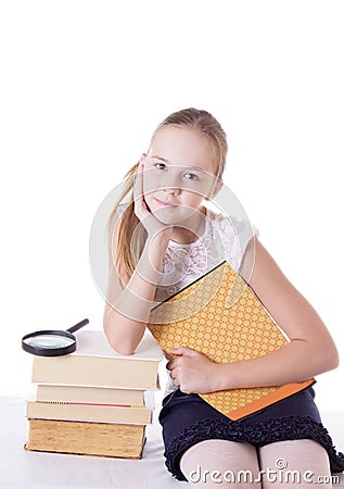 Cute schoolgirl with pile of books Stock Photo