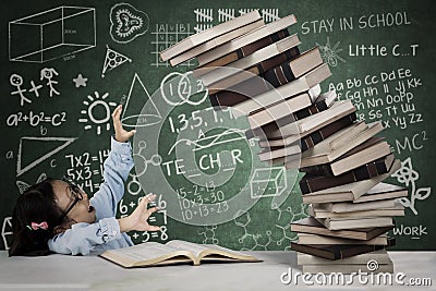 Cute schoolgirl with a pile of books Stock Photo