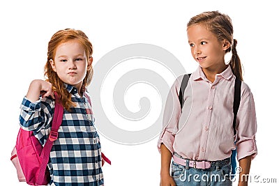 cute schoolkid looking at pupil with backpack isolated on white. Stock Photo