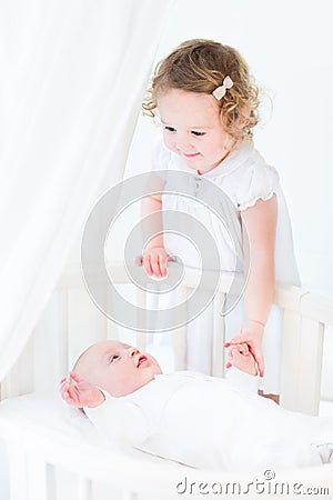 Cute siblings, little toddler girl and newborn baby Stock Photo