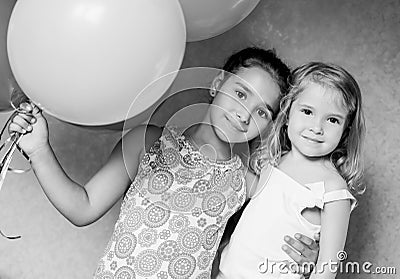 Cute sisters with balloons Stock Photo