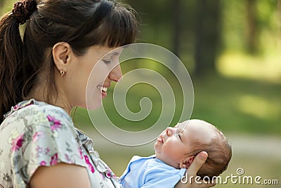 Cute sleeping newborn baby child on mother hands Stock Photo