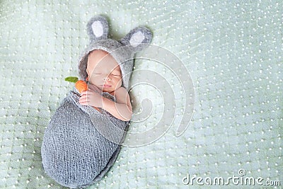 Cute sleeping newborn baby dressed like Easter bunny Stock Photo