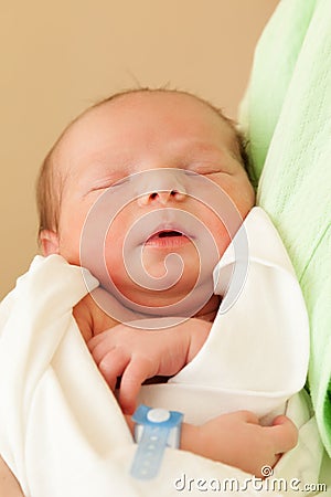 Cute sleeping newborn baby on mother hands Stock Photo