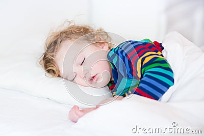 Cute sleeping toddler girl in a white bed Stock Photo