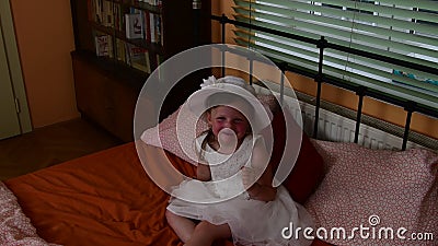 A Cute Small Girl is Sitting and Smiling on the Bed. Parents Bedroom and Her daughter(娘) is on the Bed Stock Footage - Video of dress, bedroom: 95362954 
