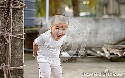 Cute smart naughty baby making a funny and looking at camera. Happy baby background Stock Photo