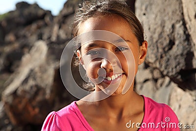 Cute smile from young mixed race girl outdoors Stock Photo