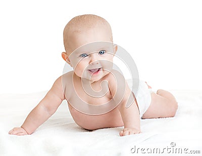 Cute smiling baby lying on white towel in nappy Stock Photo