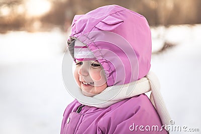 Cute smiling baby portrait in warm clothes in cold sunny winter day Stock Photo