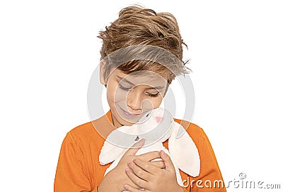 cute smiling blonde boy hugging plush white bunny.Isolated on white Stock Photo