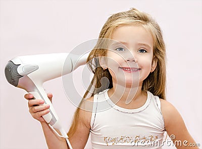 Cute smiling Little girl dries hair Stock Photo