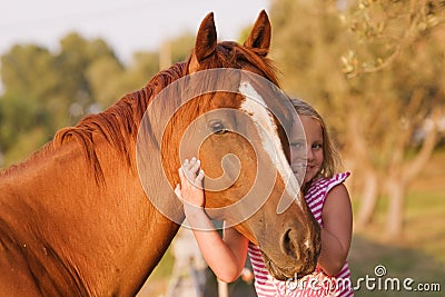 Cute smilling little girl with her handsome horse Stock Photo