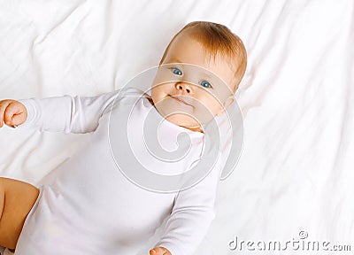 Cute sweet baby lying on the bed Stock Photo