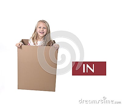 Cute and sweet blond hair child in cardboard box isolated on white background in learning english prepositions Stock Photo