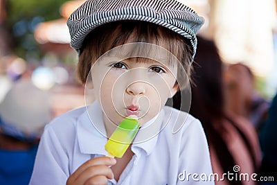 Cute sweet boy, child, eating colorful ice cream in the park Stock Photo