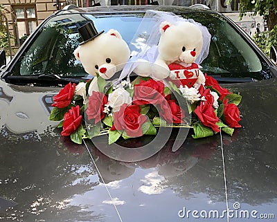 Cute teddy bear wedding ornament on a car Stock Photo