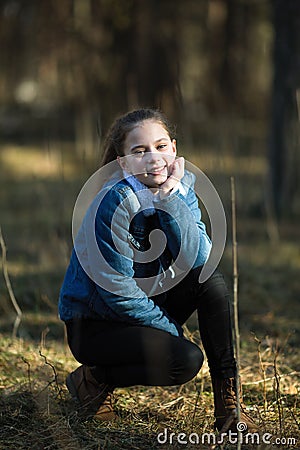 Cute fun teen girl is posing in a pine Park Stock Photo