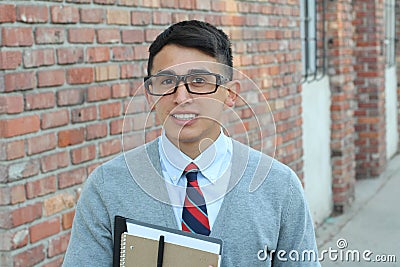 Cute teenager boy in formal high school uniform and glasses smiling Stock Photo