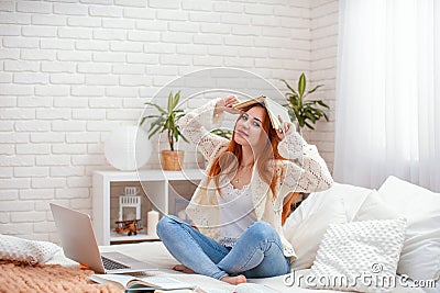 Cute teenager girl doing homework sitting on bed at home. quarantine covid-19 Stock Photo