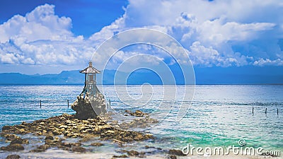Cute Temple on the Shore by the Sea on Nusa Penida with Dramatic Clouds above Bali, Indonesia Stock Photo