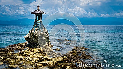 Cute Temple on the Shore by the Sea on Nusa Penida with Dramatic Clouds above Bali, Indonesia Stock Photo