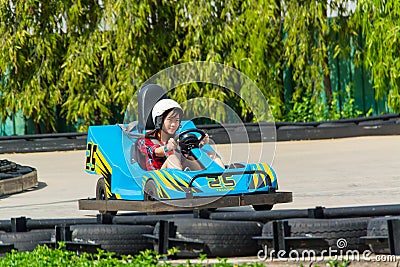 Cute Thai girl is driving Go-kart Stock Photo