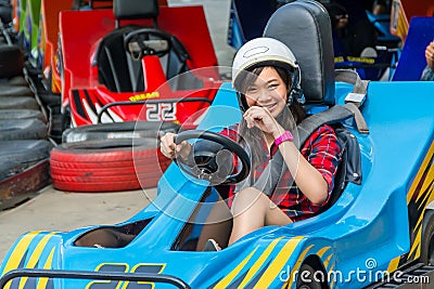 Cute Thai girl is driving Go-kart from the starting point Stock Photo