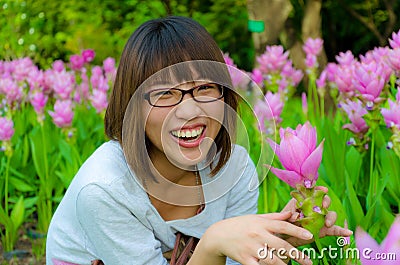 Cute Thai girl is laughing with flowers Stock Photo