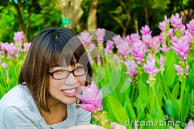 Cute Thai girl scent a pink Siam Tulip Stock Photo