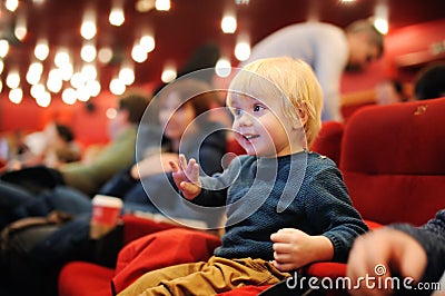 Cute toddler boy watching cartoon movie in the cinema Stock Photo