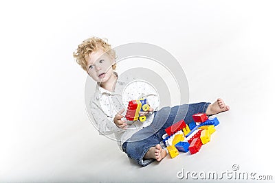 Cute toddler is building with legos Stock Photo