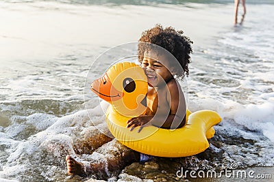 Cute toddler with duck tube on the beach Stock Photo
