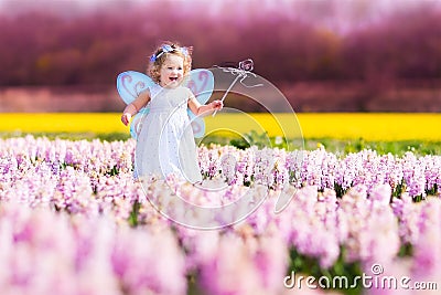 Cute toddler girl in fairy costume in a flower fie Stock Photo