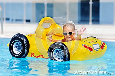 Cute toddler girl have a fun in pool outdoor Stock Photo