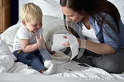 Curious toddler watching pictures of his future sibling Stock Photo