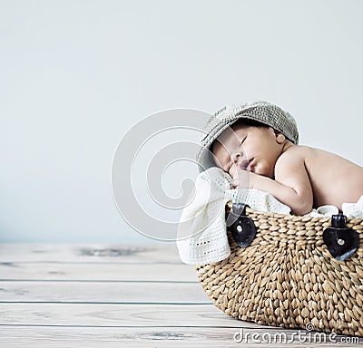 Cute tot sleeping in a basket Stock Photo